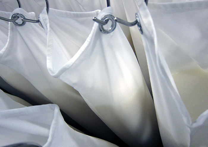 Traditional cloth bags. The moromi mash that has completed fermentation is visible inside the bags.